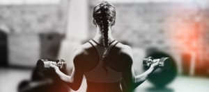 Braided hair woman lifting dumbbell